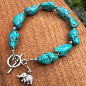Artisan-made Turquoise and sterling silver bracelet with elephant charm.
